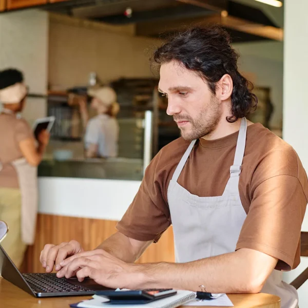 Eatery Caucasian Worker Attentively Looking Through Information Laptop Screen Sitting Table